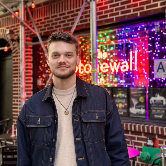 Matticus Lowery standing in front of the historic Stone Wall landmark